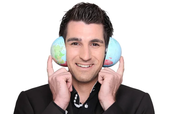 stock image Young man holding a globe