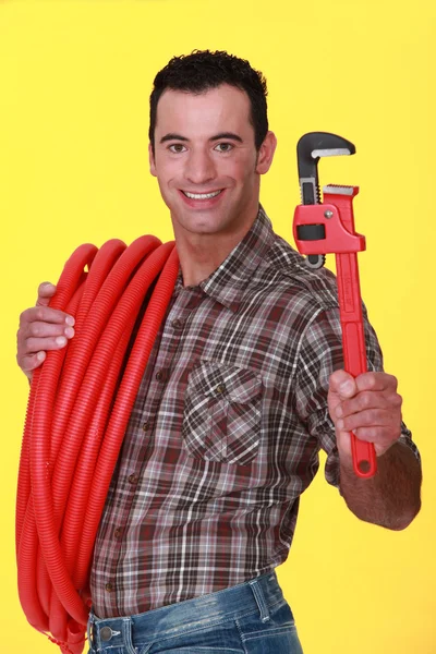 Plumber with a pipe wrench — Stock Photo, Image