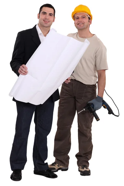Craftsman and businessman examining a blueprint — Stock Photo, Image
