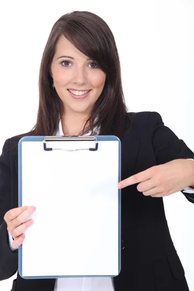 Young secretary pointing a notepad on white background Stock Picture