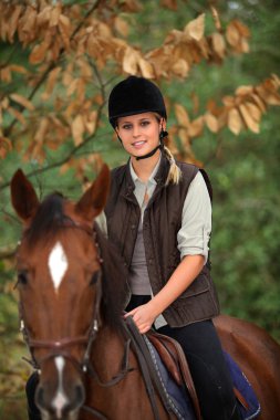 Young girl riding a horse clipart