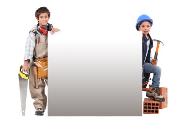 Children pretending to be construction workers standing around a blank sign clipart