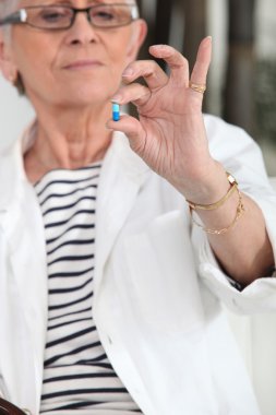 Old woman with drug in hand clipart