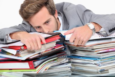 Man drowning in stacks of paperwork clipart