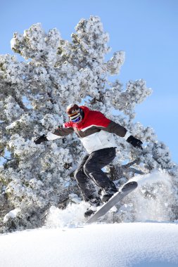 Man performing jump on snowboard clipart