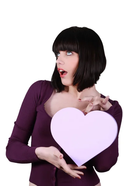 Woman holding a plastic heart — Stock Photo, Image
