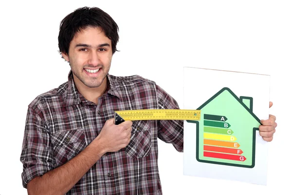 Hombre con un signo de calificación energética — Foto de Stock