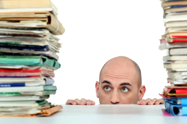 Man staring nervously at piles of folders — Stock Photo, Image