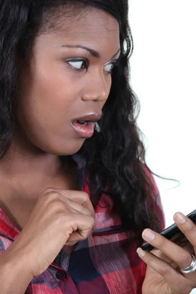 Bust shot of young black woman looking stunned — Stock Photo, Image