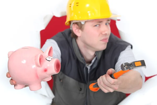Builder with hammer and piggy-bank — Stock Photo, Image