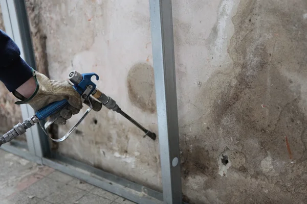Man spraying inslation into walls — Stock Image Man spraying inslation into walls Stock Image