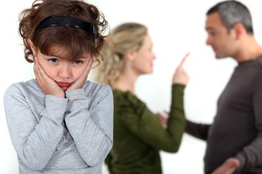 Cute little girl distressed over parents' quarrel clipart