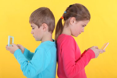 Brother and sister with hand-held video games clipart