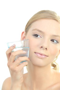 Blond woman holding glass of water to face clipart