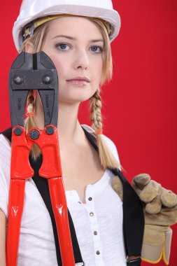 Female manual worker holding industrial cutters clipart