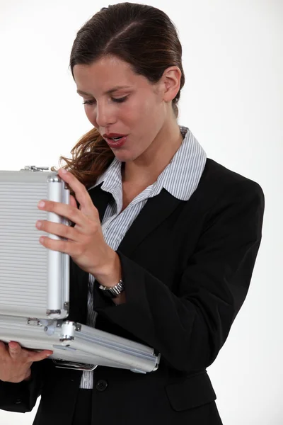 Woman opening metal briefcase — Stock Photo, Image