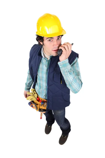 Handyman speaking into radio unit — Stock Photo, Image