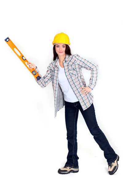 Woman with a spirit level — Stock Photo, Image
