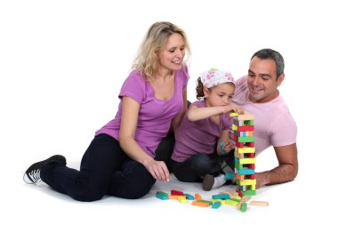 Family playing with building blocks clipart
