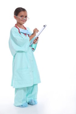 Child in a doctors scrubs with stethoscope and clipboard clipart