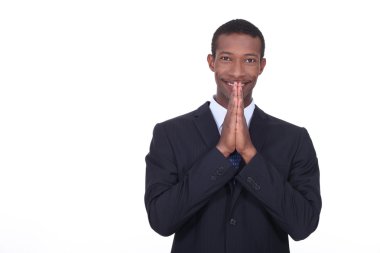 African businessman hoping for good news clipart