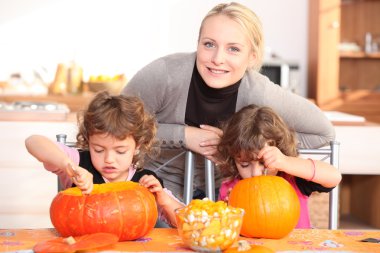 Mother and child preparing pumpkin clipart