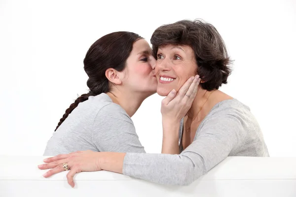 Enkelin küsst Großmutter — Stockfoto