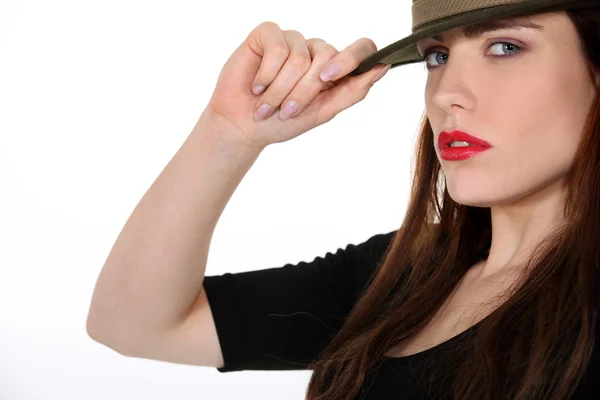 Portrét sexy bruneta s kloboukem drží krempou — Stock fotografie
