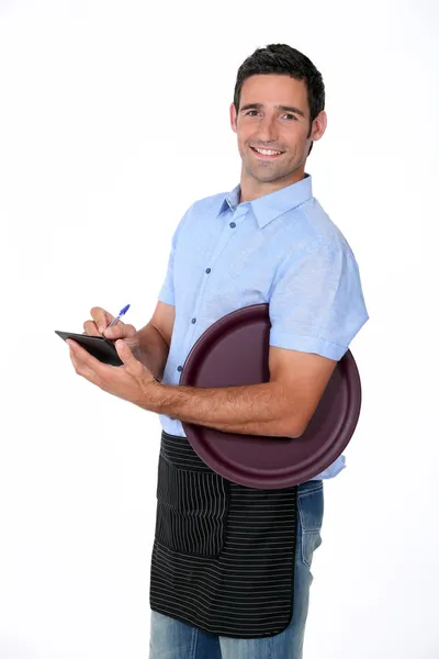 Camarero casual con bandeja y bloc de notas — Foto de Stock