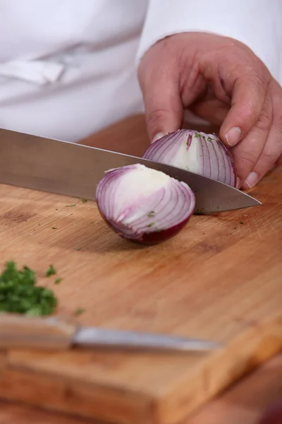 Chef chopping an onion — Stock Photo, Image