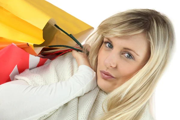 Blond woman holding shopping bags — Stock Photo, Image
