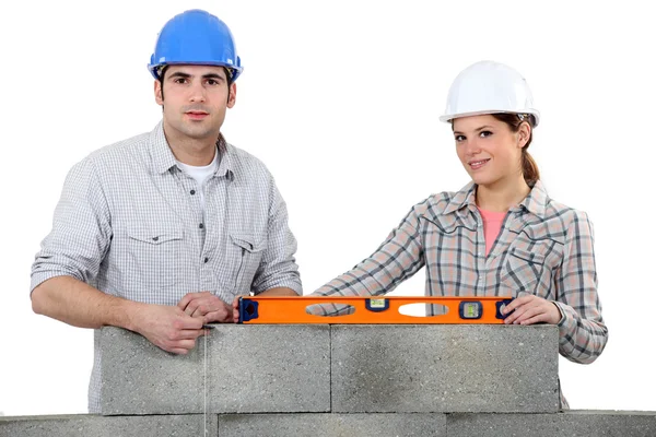 Hantverkare och hantverkerska uppföra en mur — Stockfoto