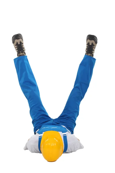 Builder on his back with his legs in a V — Stock Photo, Image