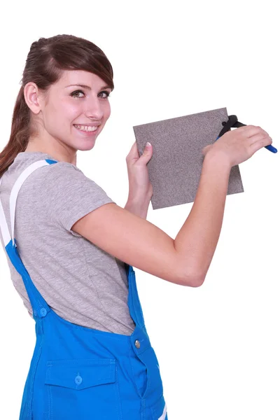 Woman cutting tile — Stock Photo, Image