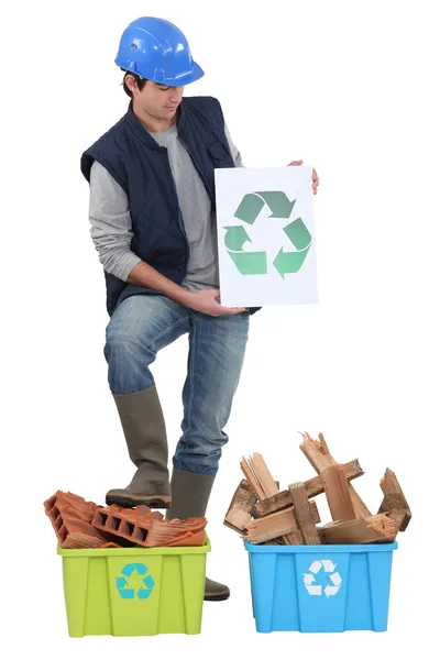 Builder stood by materials to be recycled — Stock Photo, Image