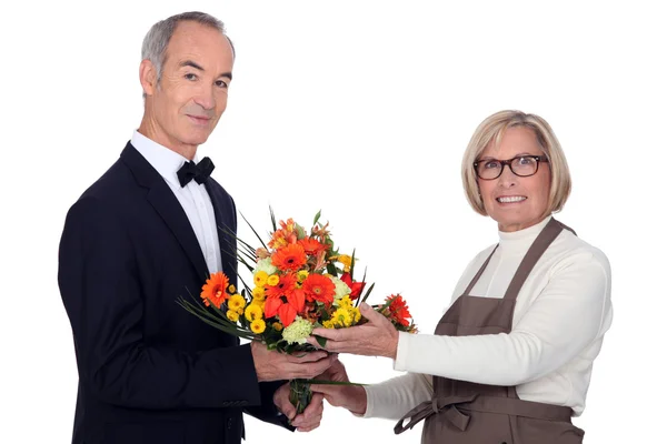 Человек в костюме покупает цветы — стоковое фото