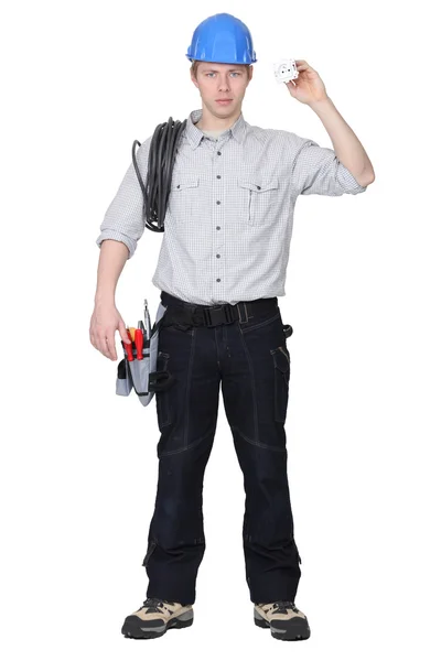 Electrician holding cable and electrical socket — Stock Photo, Image