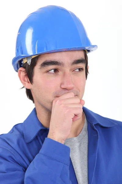 Closeup portrait of young craftsman looking amused with hand to his mouth — Stock Photo, Image