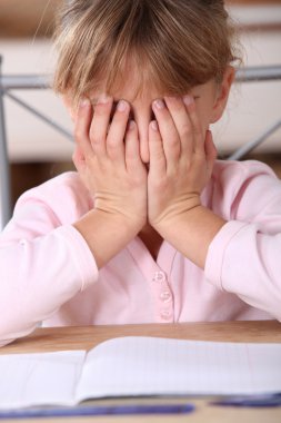Frustrated girl unable to complete her homework clipart