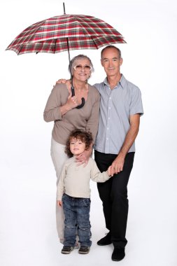 Grandparents posing with their grandchild clipart