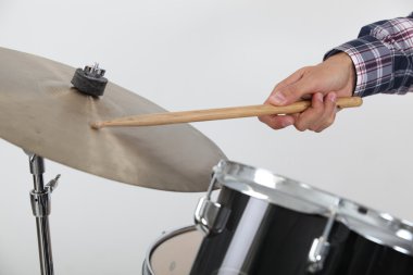 Drummer hitting a cymbal clipart