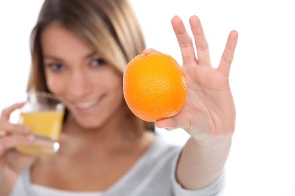 Γυναίκα πίνοντας ένα φρεσκοστυμμένο χυμό πορτοκαλιού — Φωτογραφία Αρχείου