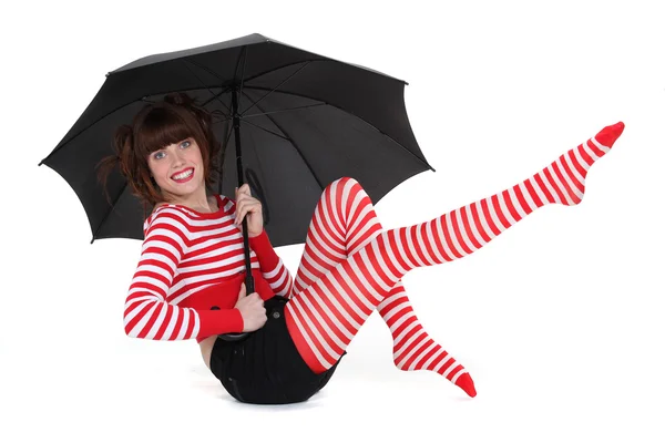 Woman with funky tights under an umbrella — Stock Photo, Image