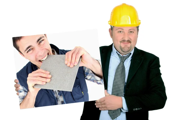 Portrait of foreman holding picture of young tiler — Stock Photo, Image
