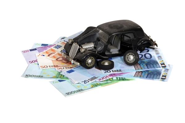 Model of an old car on a pile of banknotes — Stock Photo, Image