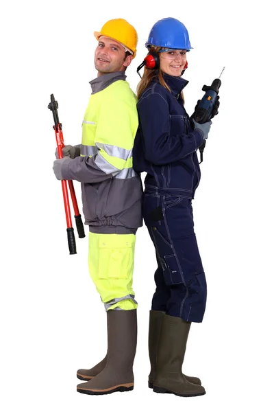 Manliga och kvinnliga byggnadsarbetare — Stockfoto