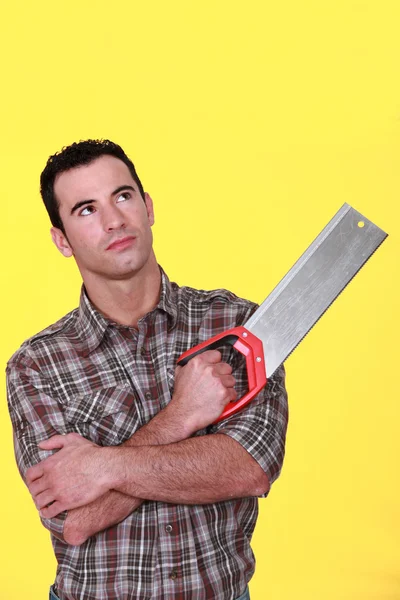Man holding a saw — Stockfoto