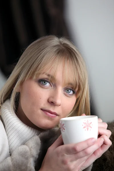 Woman drinking a hot drink — Stock Photo, Image
