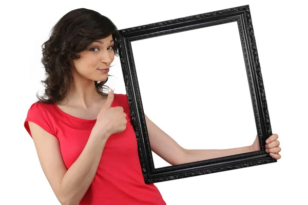 Woman holding a picture frame — Stock Photo, Image