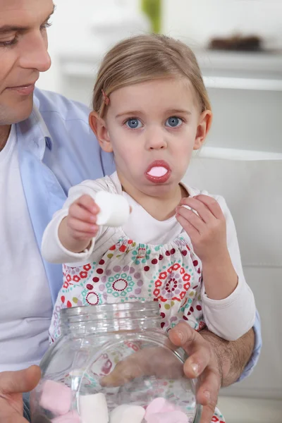 Little girl eating candy — Stock Photo, Image